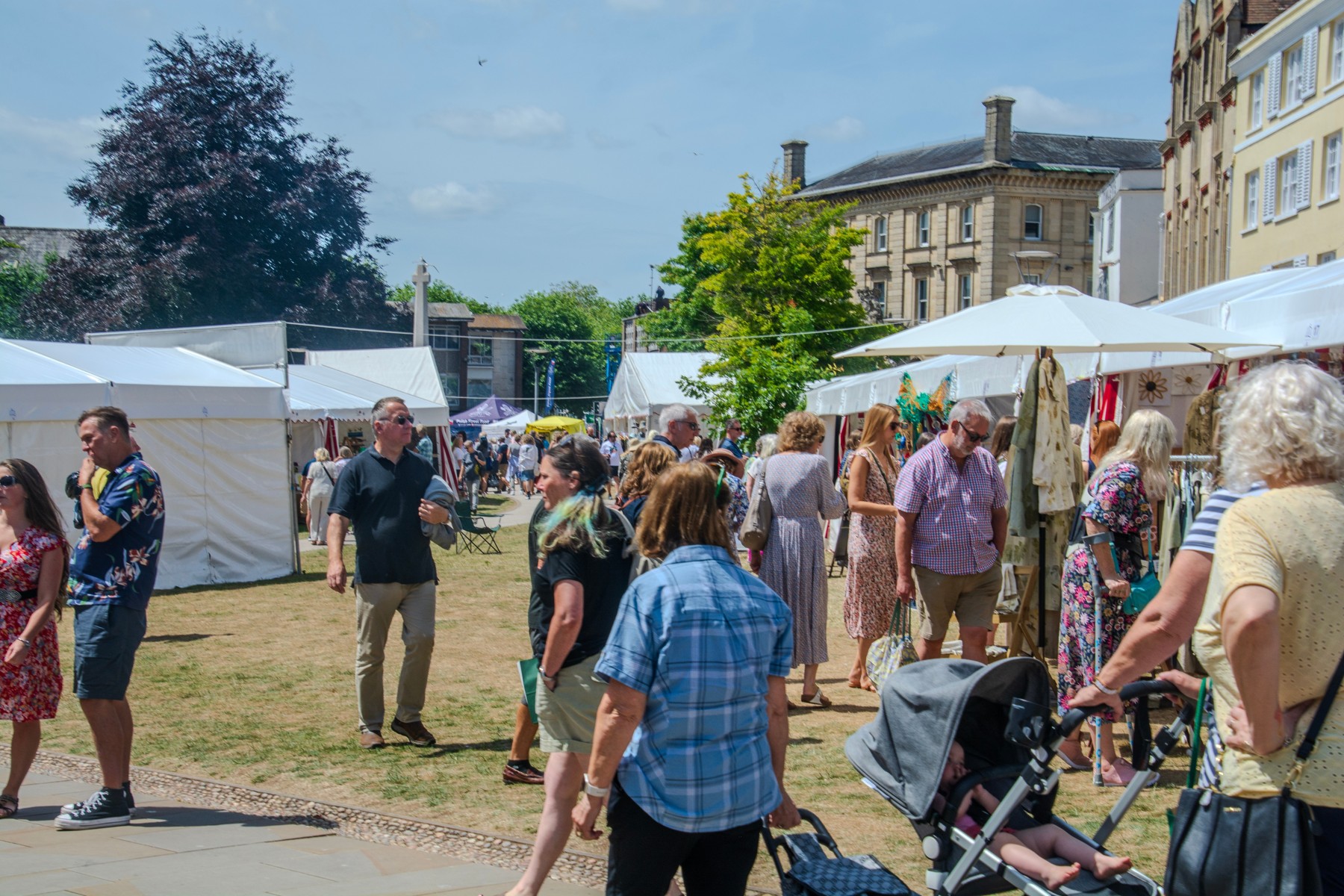 People browsing stalls on Cathedral Green in Exeter